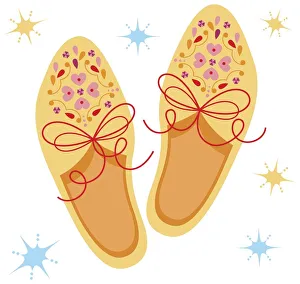 Pair of yellow shoes decorated with pink floral pattern Pair of yellow shoes decorated with pink floral pattern
