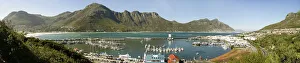 A panoramic picture of Hout Bay with Hout Bay Beach on the left and the marina and fishing harbour in the foreground A panoramic picture of Hout Bay with Hout Bay Beach on the left and the marina and fishing harbour in the foreground