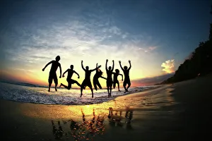 People jumping on beach at sunset in Costa Rica People jumping on beach at sunset in Costa Rica