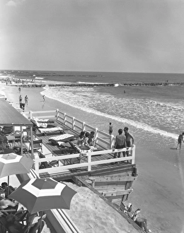 People relaxing on beach, (B&W), elevated view People relaxing on beach, (B&W), elevated view