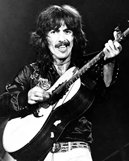 Prints of SAN FRANCISCO - NOVEMBER 6: Guitarist George Harrison, fomerly of the rock and roll band The Beatles, performs onstage with an electric guitar at the Cow Palace on November 6, 1975 in San Francisco Music Prints: George Harrison Performs Acoustic Print at Cow Palace 1975