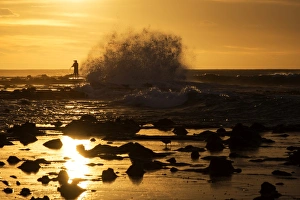 A photographer and the big wave at Curio Bay A photographer and the big wave at Curio Bay
