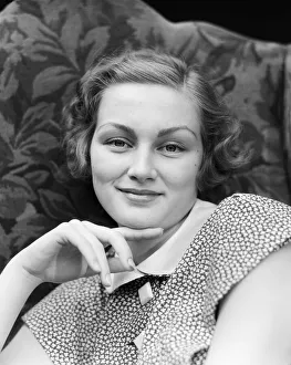 Portrait of smiling woman, chin resting on index finger Portrait of smiling woman, chin resting on index finger