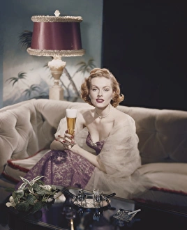 Portrait of a young woman sitting holding a beer glass Portrait of a young woman sitting holding a beer glass