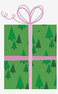 Present with tree pattern wrapping paper and pink bow at the top Present with tree pattern wrapping paper and pink bow at the top