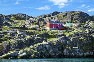Red house on rocky coastline, Sisimiut, Greenland Red house on rocky coastline, Sisimiut, Greenland