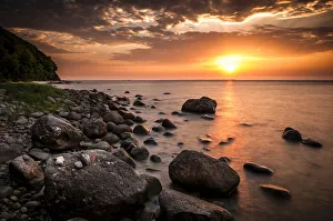 Rocks on a beach at sunset by the sea, bei Nardewitz, Rugen island, Rugen, Mecklenburg-Western Pomerania, Germany Rocks on a beach at sunset by the sea, bei Nardewitz, Rugen island, Rugen, Mecklenburg-Western Pomerania, Germany