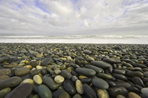 Rocky beach with waves breaking in background Rocky beach with waves breaking in background