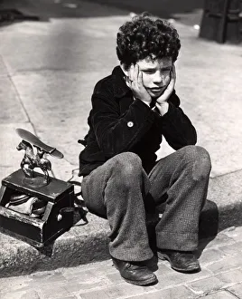 Sad Boy, Curly Hair Sitting On Curb Patched Trousers Shoeshine Kit Work Working Worker Sad Boy, Curly Hair Sitting On Curb Patched Trousers Shoeshine Kit Work Working Worker