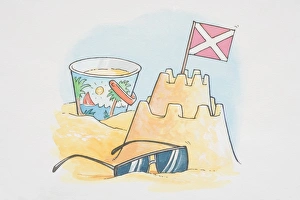 Sand castle with flag, bucket and pair of sunglasses Sand castle with flag, bucket and pair of sunglasses