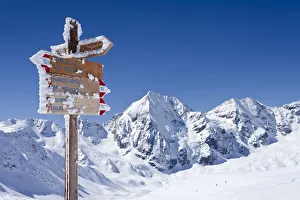 Signpost on Madritschjoch ridge, Sulden in winter, Monte Zebru mountain and Koenigsspitze mountain at the back Signpost on Madritschjoch ridge, Sulden in winter, Monte Zebru mountain and Koenigsspitze mountain at the back