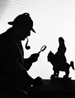 Silhouette of man wearing deerstalker, dressed as Sherlock Holmes. (Photo by H Silhouette of man wearing deerstalker, dressed as Sherlock Holmes. (Photo by H
