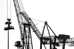 Silhouetted profile of construction cranes Silhouetted profile of construction cranes