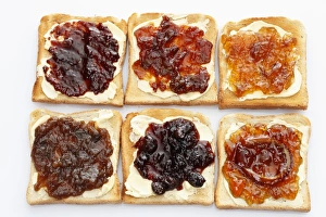 Six slices of toast with various jams, rhubarb jam, apricot jam, strawberry jam, orange marmalade Six slices of toast with various jams, rhubarb jam, apricot jam, strawberry jam, orange marmalade