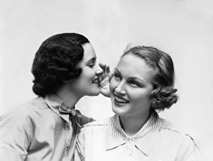 Two Smiling Women The 1 Wearing The Blouse With A Bowtie Is Wispering A Secret In The Ear Two Smiling Women The 1 Wearing The Blouse With A Bowtie Is Wispering A Secret In The Ear