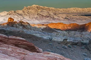 Snow covered mountains and different geological layers of rock, Valley of Fire State Park, Nevada, USA Snow covered mountains and different geological layers of rock, Valley of Fire State Park, Nevada, USA