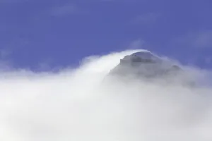 South Georgia, mountain peak enshrouded in fog, autumn morning South Georgia, mountain peak enshrouded in fog, autumn morning