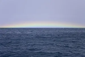 South Georgia, rainbow over calm sea, autumn South Georgia, rainbow over calm sea, autumn