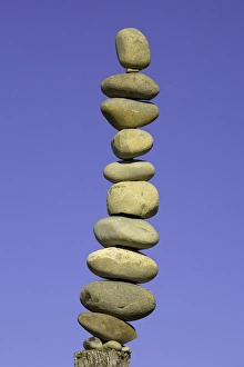 Stack of stones on fence post, low angle view Stack of stones on fence post, low angle view