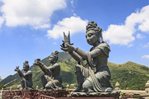Statues of Devas making offerings at Tian Tan Buddha image at Po Lin Monastery, Lantau Island, Hong Kong, China Statues of Devas making offerings at Tian Tan Buddha image at Po Lin Monastery, Lantau Island, Hong Kong, China