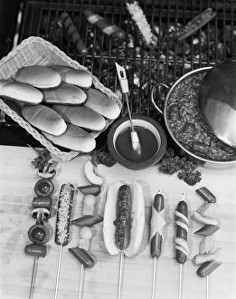 Stew with sausage skewers and basket of breads Stew with sausage skewers and basket of breads