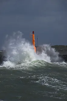 Strong waves with spray in a storm at the pier of Hvide Sande, Jutland, Denmark, Europe Strong waves with spray in a storm at the pier of Hvide Sande, Jutland, Denmark, Europe