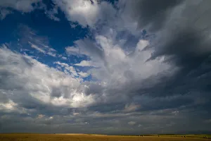 Summer morning massive cloud formations over wheat fields on South Dakota prairie, USA Summer morning massive cloud formations over wheat fields on South Dakota prairie, USA