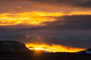 Sun breaking through the clouds, sunset, Myvatn area, Norourland eystra, Iceland Sun breaking through the clouds, sunset, Myvatn area, Norourland eystra, Iceland