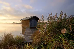 Sunrise with a fishermans hut and a light morning mist near Rimsting on Lake Chiemsee, Bavaria, Germany, Europe Sunrise with a fishermans hut and a light morning mist near Rimsting on Lake Chiemsee, Bavaria, Germany, Europe