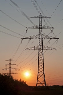 Sunset behind a power pylon, Lueneburg, Lower Saxony, Germany, Europe Sunset behind a power pylon, Lueneburg, Lower Saxony, Germany, Europe