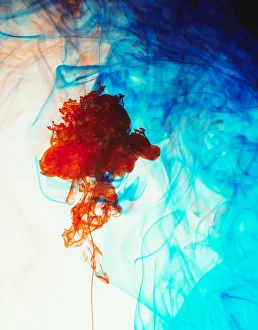 Swirls of floating orange and blue ink in liquid Swirls of floating orange and blue ink in liquid