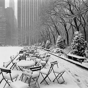 Tables and chairs in park covered with snow, New York City Tables and chairs in park covered with snow, New York City