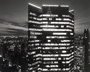 Tall office building with lights on at night Tall office building with lights on at night