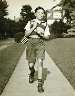 Teenage boy (13-14) going to school, suburbs, (B&W) Teenage boy (13-14) going to school, suburbs, (B&W)