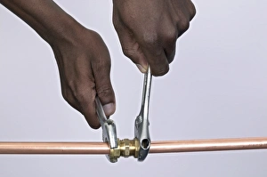 Tightening nuts to a compression joint attached to copper pipes using adjustable spanners Tightening nuts to a compression joint attached to copper pipes using adjustable spanners