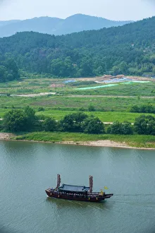 Traditional dragon boat, Baengma River, Buso mountain fortress in Busosan park Buyeu Traditional dragon boat, Baengma River, Buso mountain fortress in Busosan park Buyeu