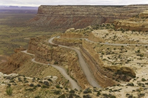 USA, Utah, cars on dirt road climbing plateau in desert, autumn USA, Utah, cars on dirt road climbing plateau in desert, autumn