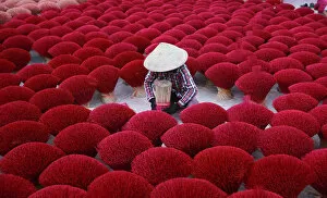 Simplicity in Focus: A Minimal Art Photography Collection: Vietnam - woman making red insense