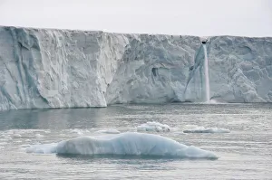Waterfall of meltwater at the glacier front of Brasvellbreen, the longest glacier front in the northern hemisphere Waterfall of meltwater at the glacier front of Brasvellbreen, the longest glacier front in the northern hemisphere