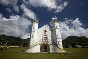 White church on a grass field with blue sky White church on a grass field with blue sky