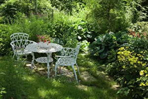 White metal garden table and chairs in a residential backyard, Quebec City, Quebec Province, Canada White metal garden table and chairs in a residential backyard, Quebec City, Quebec Province, Canada