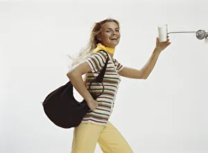 Woman with handbag holding glass of milk, close-up Woman with handbag holding glass of milk, close-up
