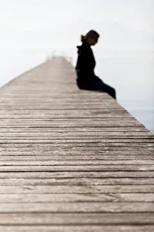 Woman sitting on a wooden jetty, Chiemsee Lake, Bavaria, Germany, Europe, PublicGround Woman sitting on a wooden jetty, Chiemsee Lake, Bavaria, Germany, Europe, PublicGround