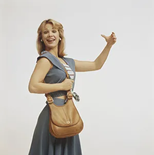 Woman standing with handbag and gesturing, close-up Woman standing with handbag and gesturing, close-up