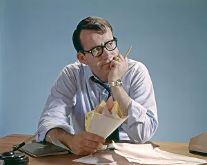 Worried Looking Man With Glasses At Desk Clutching Papers Bills Debt Concern Money Pencil Worried Looking Man With Glasses At Desk Clutching Papers Bills Debt Concern Money Pencil