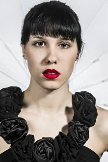 Young woman in black dress with fabric roses, portrait Young woman in black dress with fabric roses, portrait