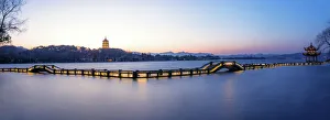 A zig zag bridge agsinst Leifeng Pagoda on the West Lake, Hangzhou A zig zag bridge agsinst Leifeng Pagoda on the West Lake, Hangzhou