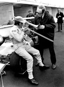 Brands Hatch, Kent: Racing driver Jackie Stewart, of Scotland, isn't really blowing Brands Hatch, Kent: Racing driver Jackie Stewart, of Scotland, isn't really blowing