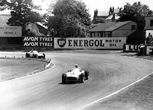 Driver Collection: British racing driver Stirling Moss No 12, takes the lead from Fangio of Argentina