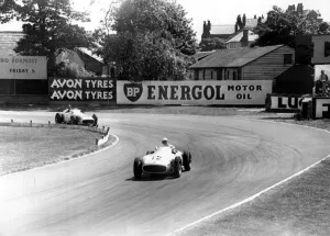 British racing driver Stirling Moss No 12, takes the lead from Fangio of Argentina British racing driver Stirling Moss No 12, takes the lead from Fangio of Argentina